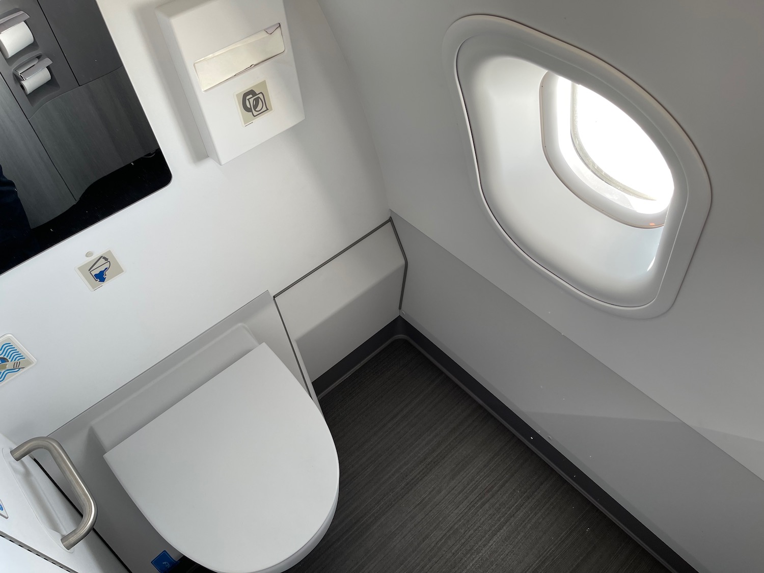 a toilet and window in a plane