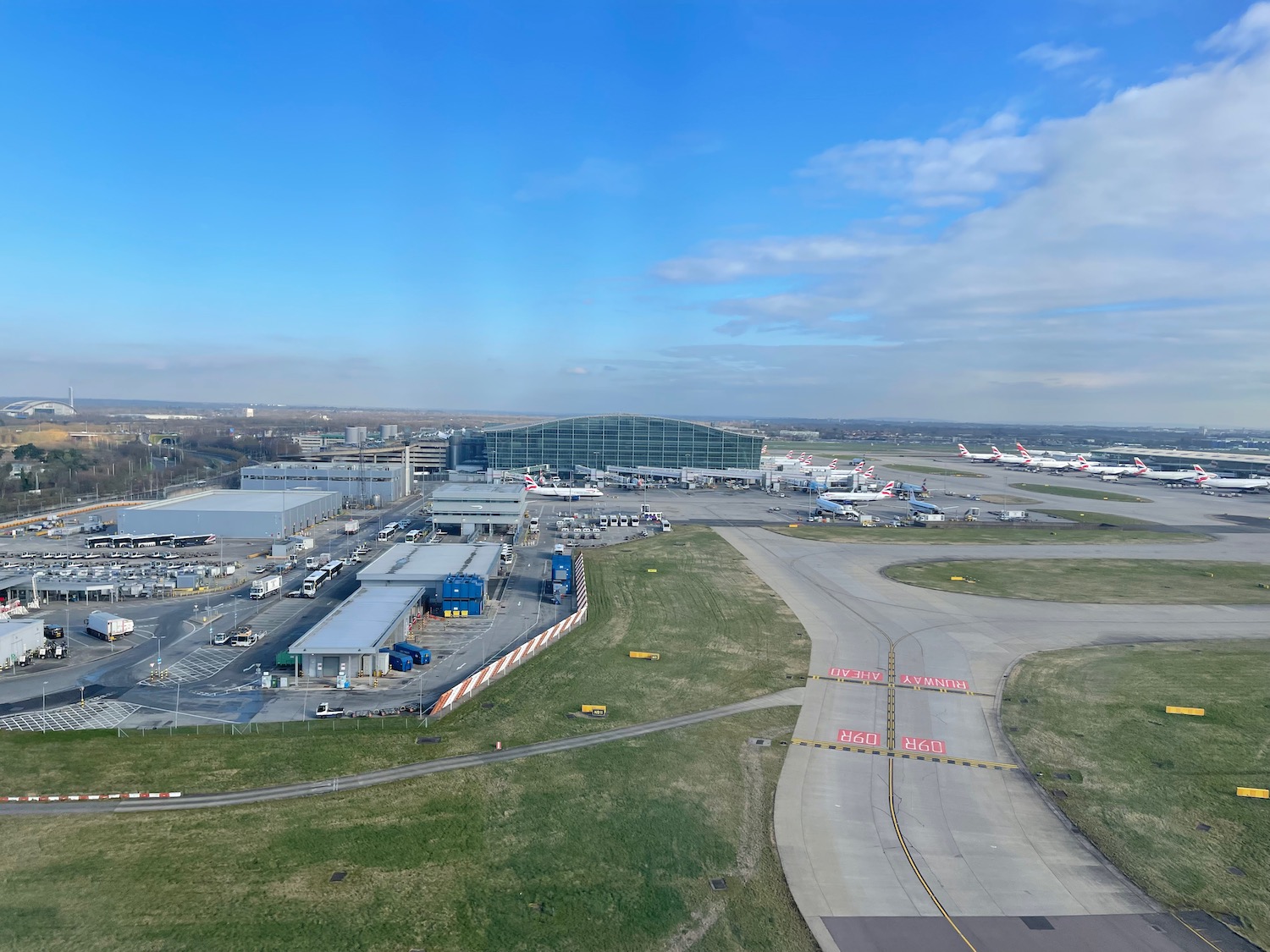 an airport with a runway and buildings