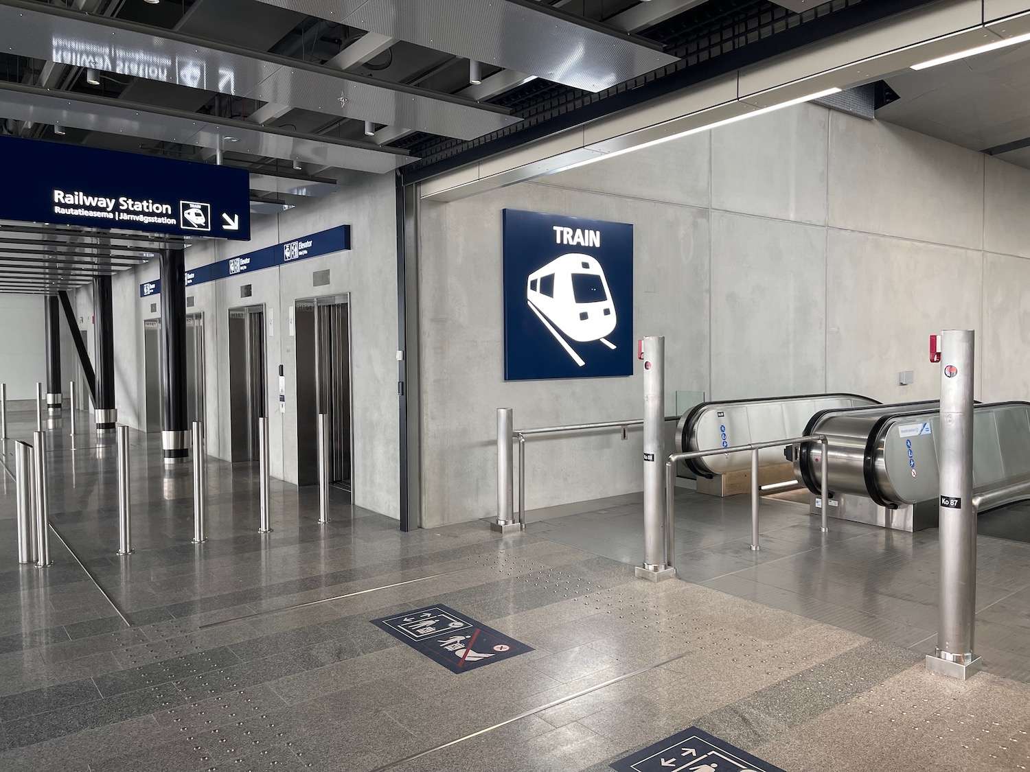 a train station with escalators and signs