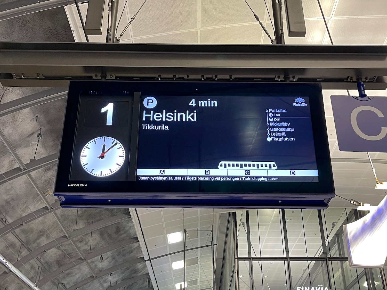 a digital sign with a train and time