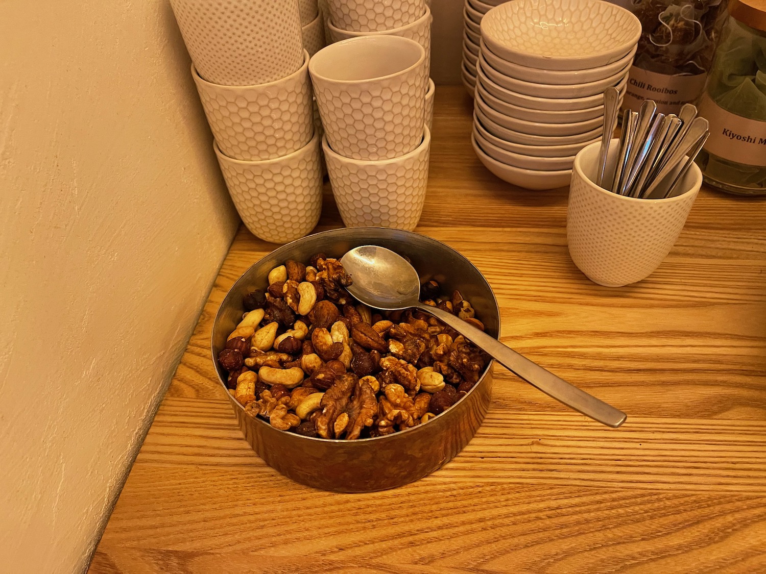 a bowl of nuts and a spoon