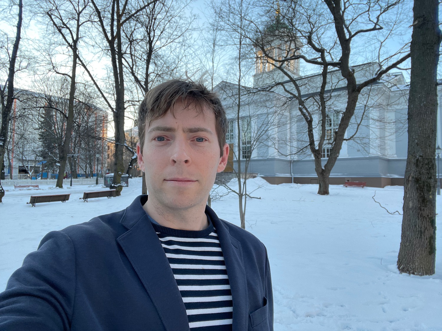 a man taking a selfie in front of a building