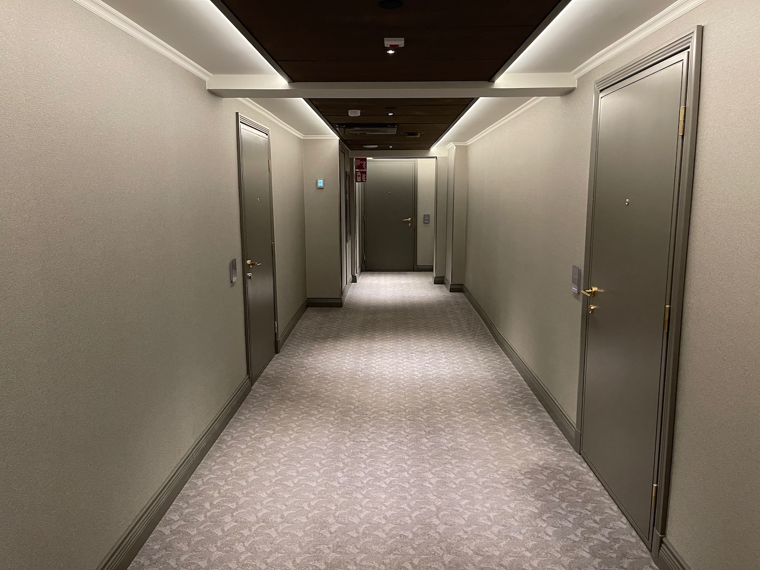 a hallway with doors and carpet