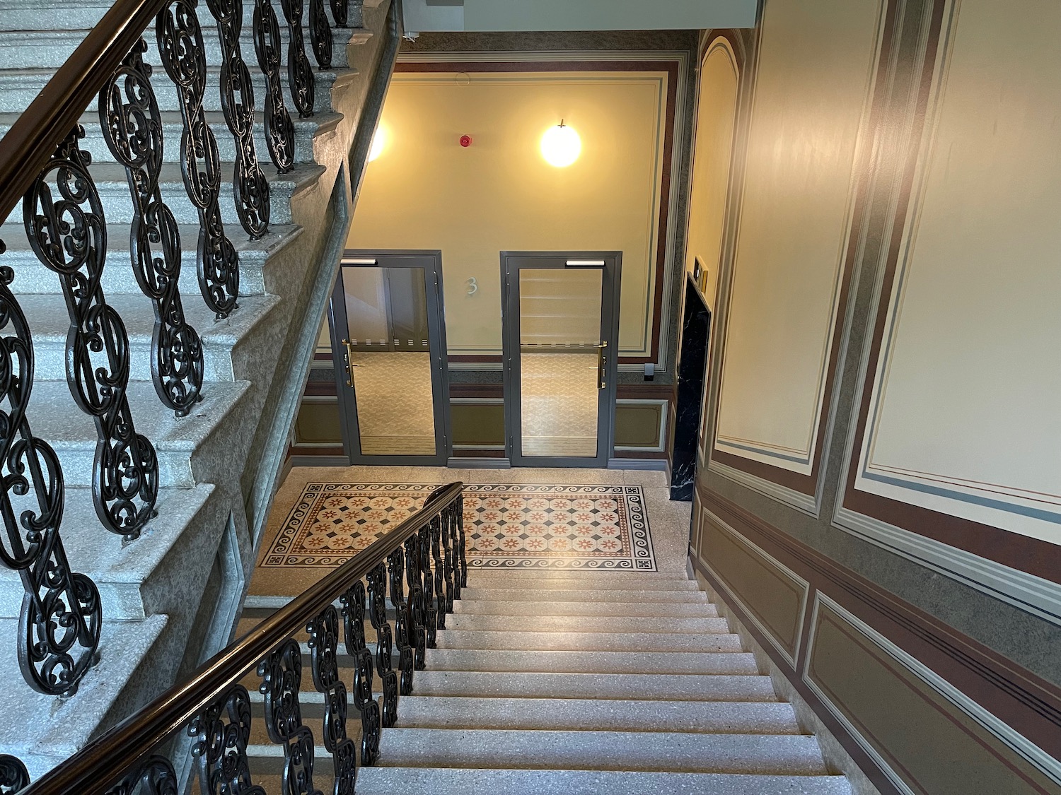 a staircase with a railing and a door