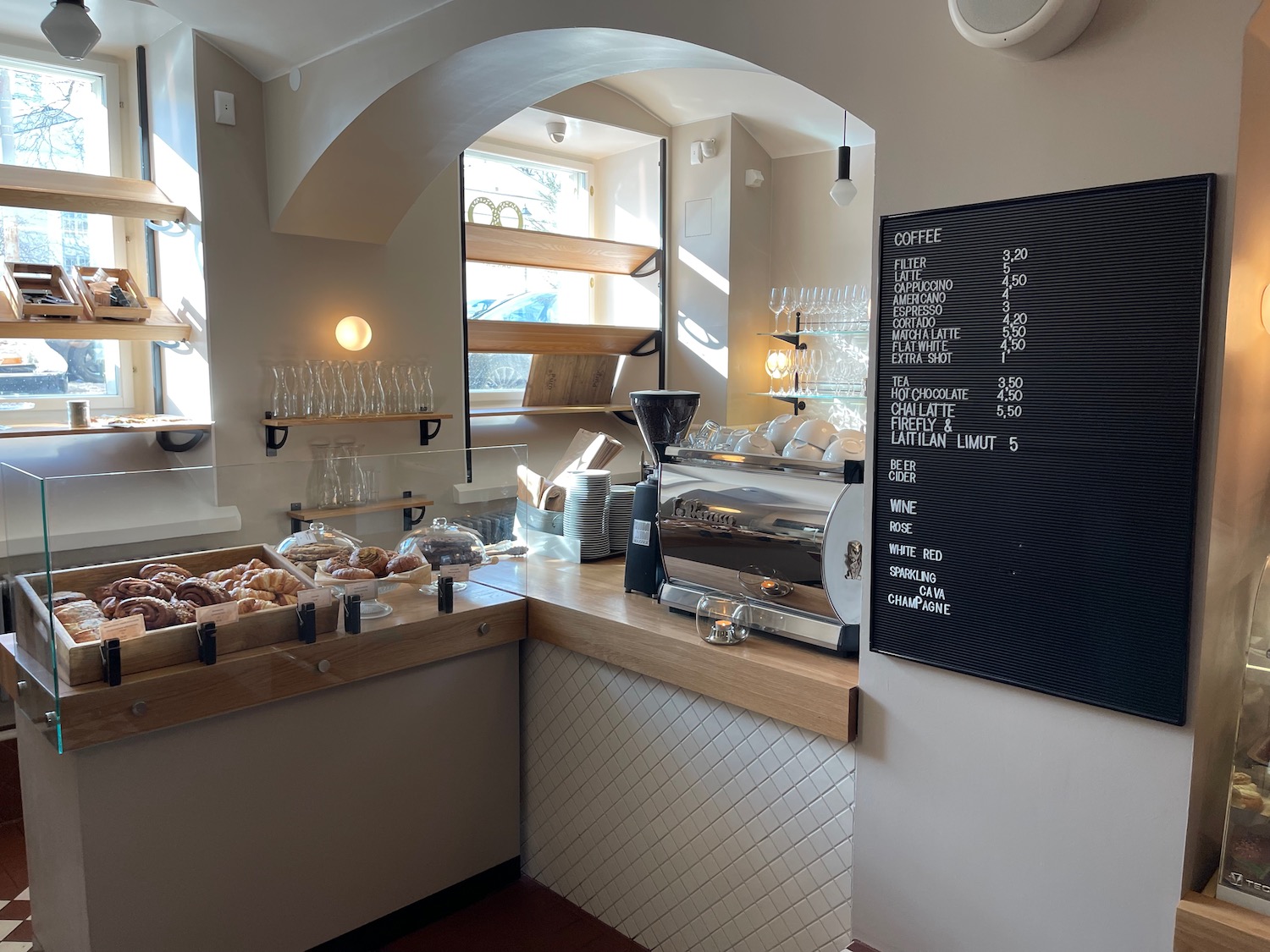 a coffee shop with a menu board