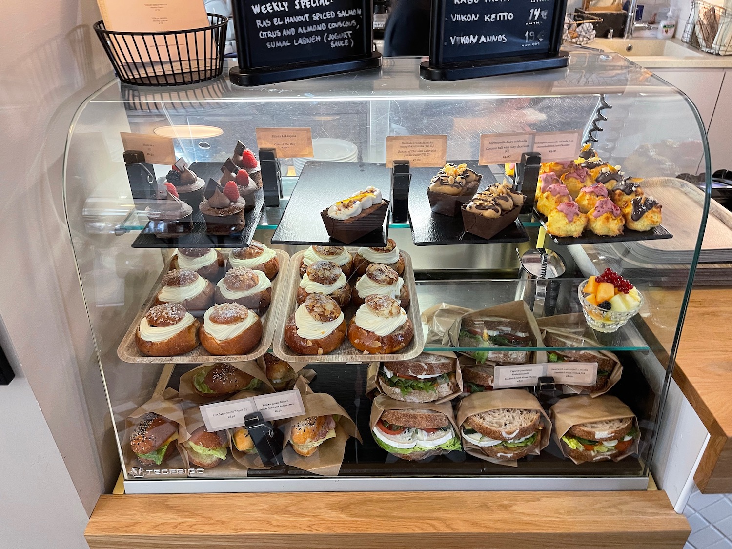 a display case with pastries and desserts