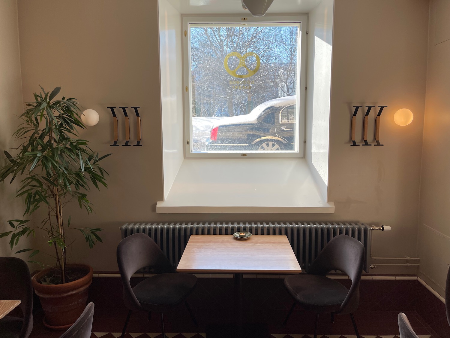 a table and chairs in a room with a window