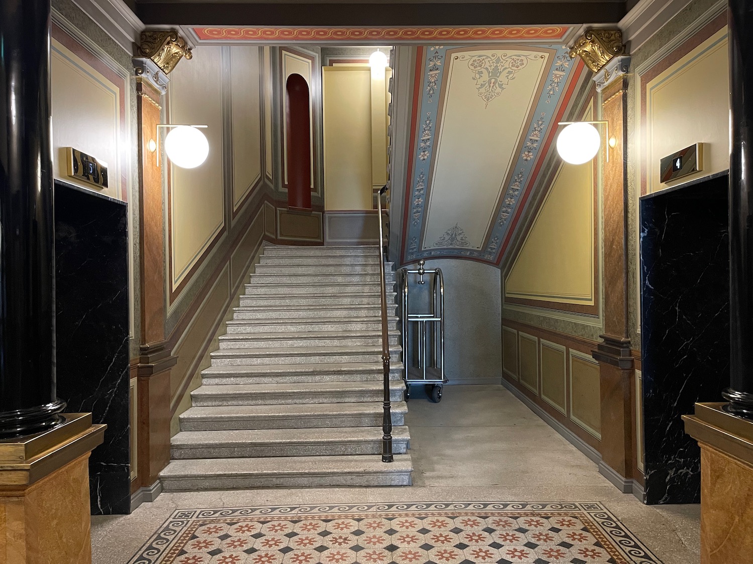 a staircase with lights on the ceiling