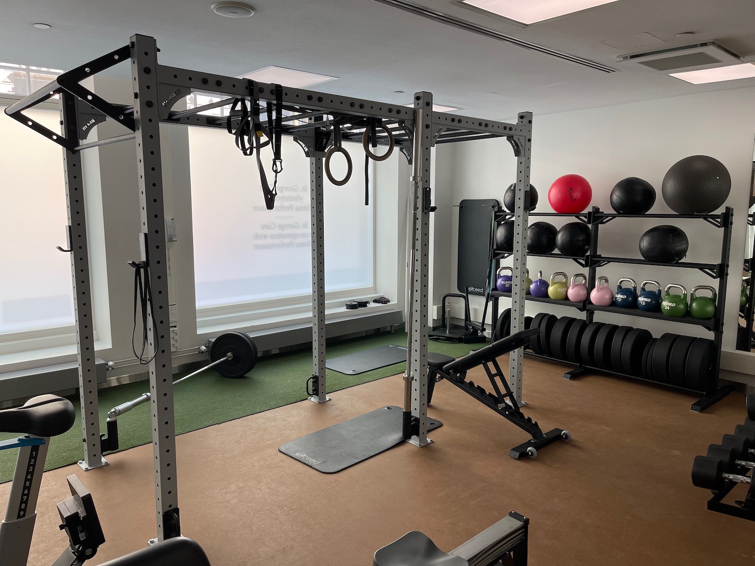 a gym with equipment and a large window