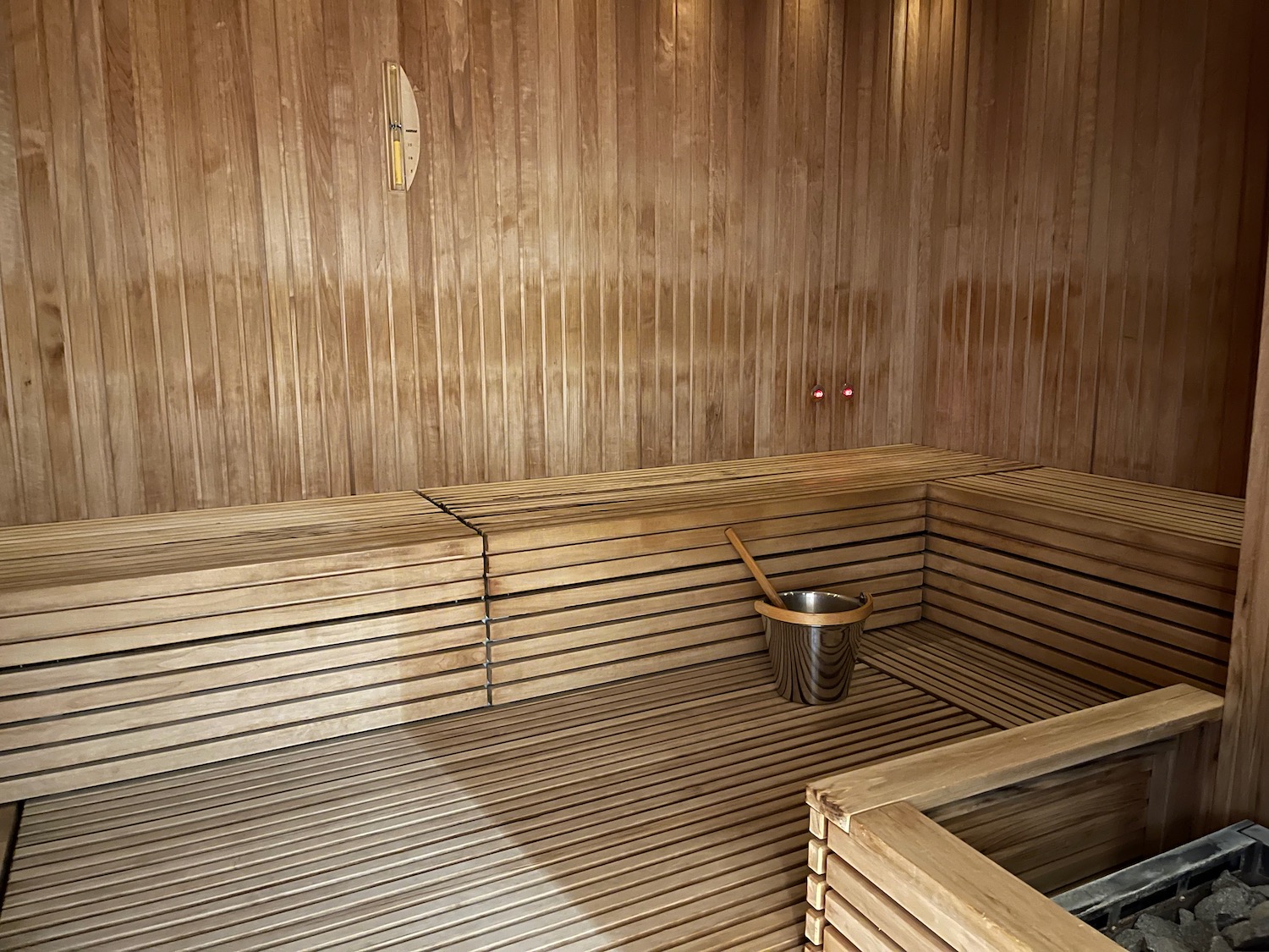a wooden sauna with bucket and scoop