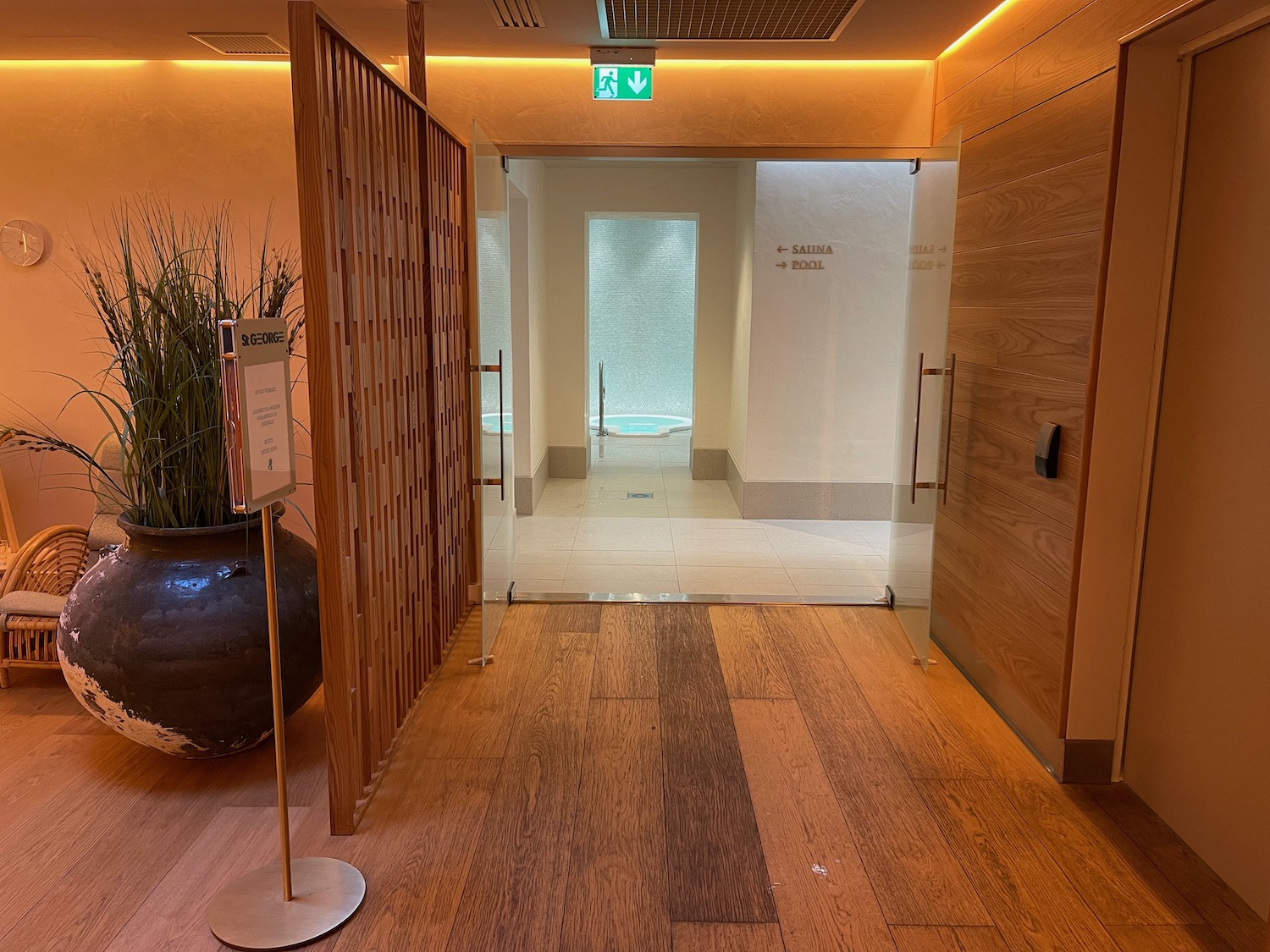 a room with a glass door and a potted plant