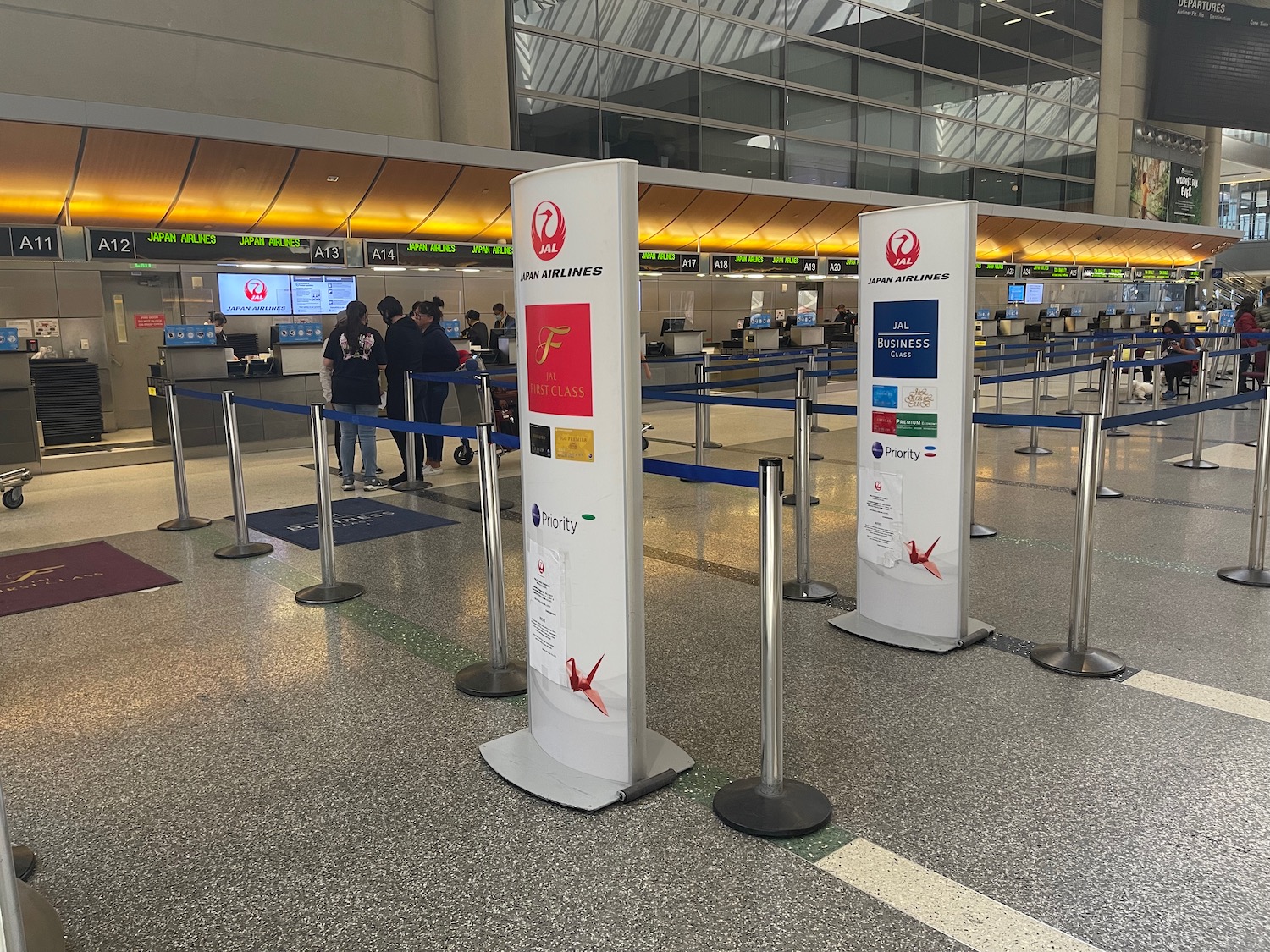 a group of people standing in a line in an airport