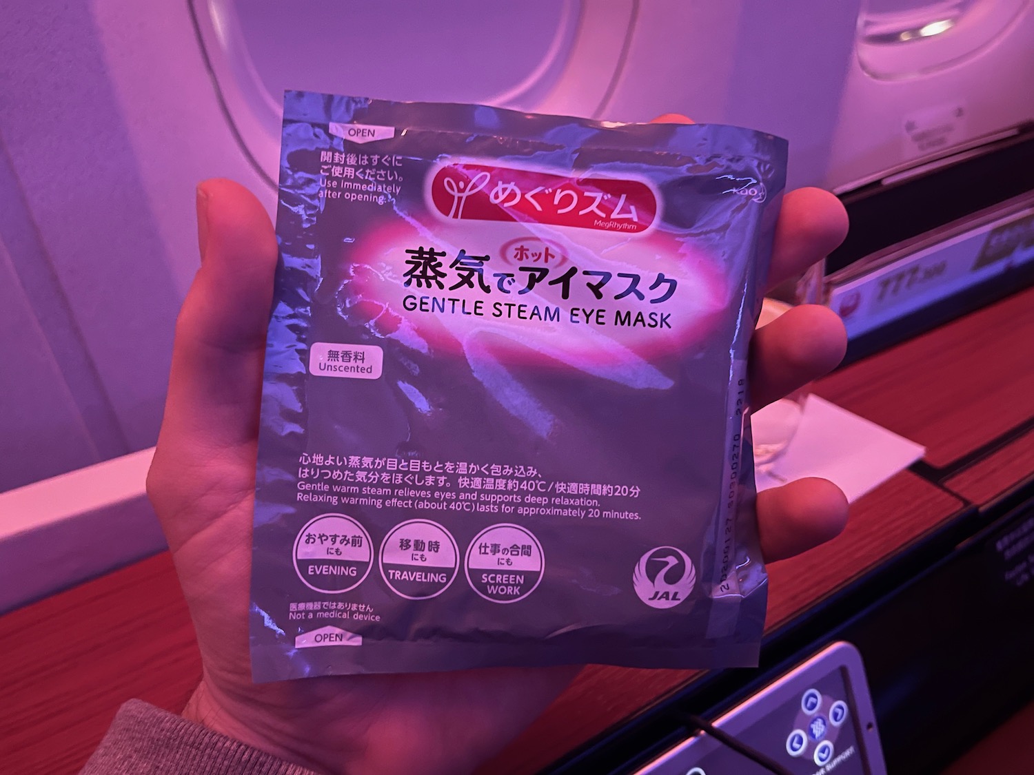 a hand holding a package of steam eye mask