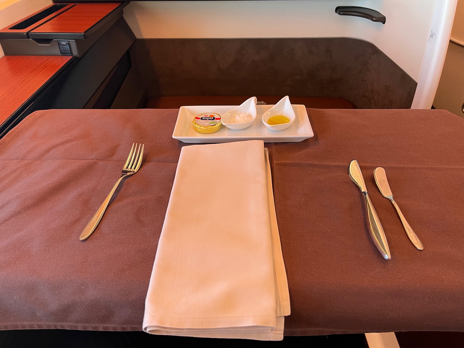 a table with a plate of food and a napkin