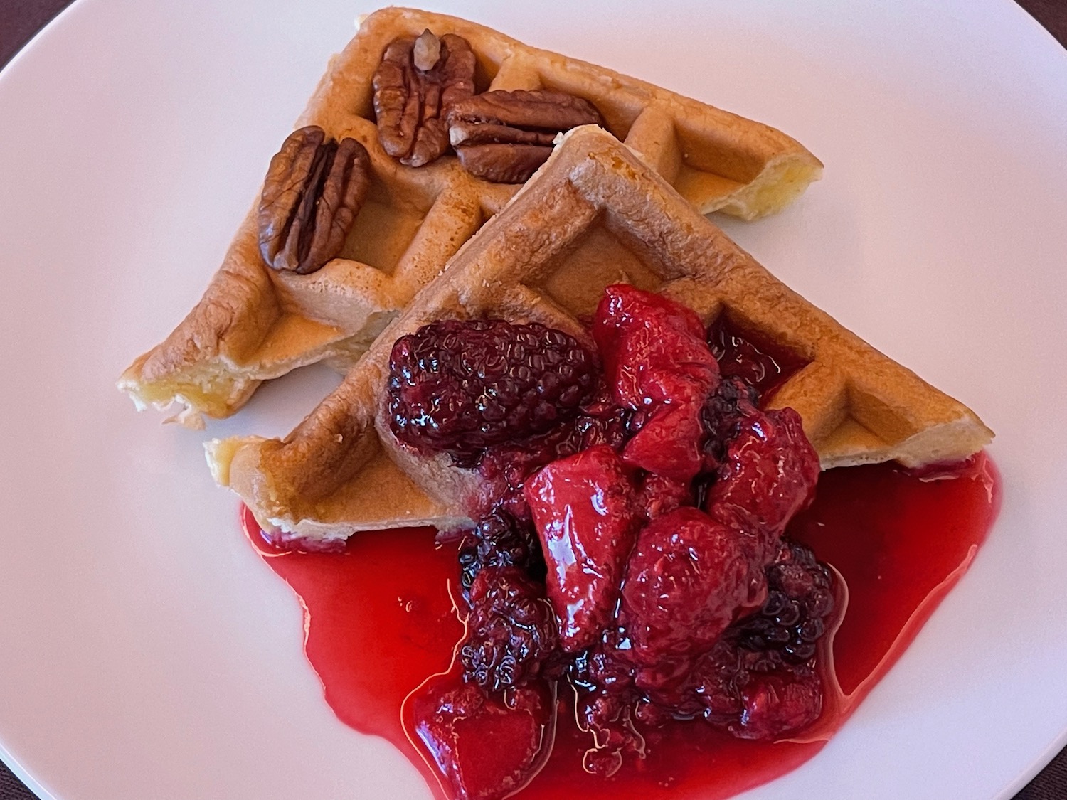 waffles with fruit sauce on a white plate