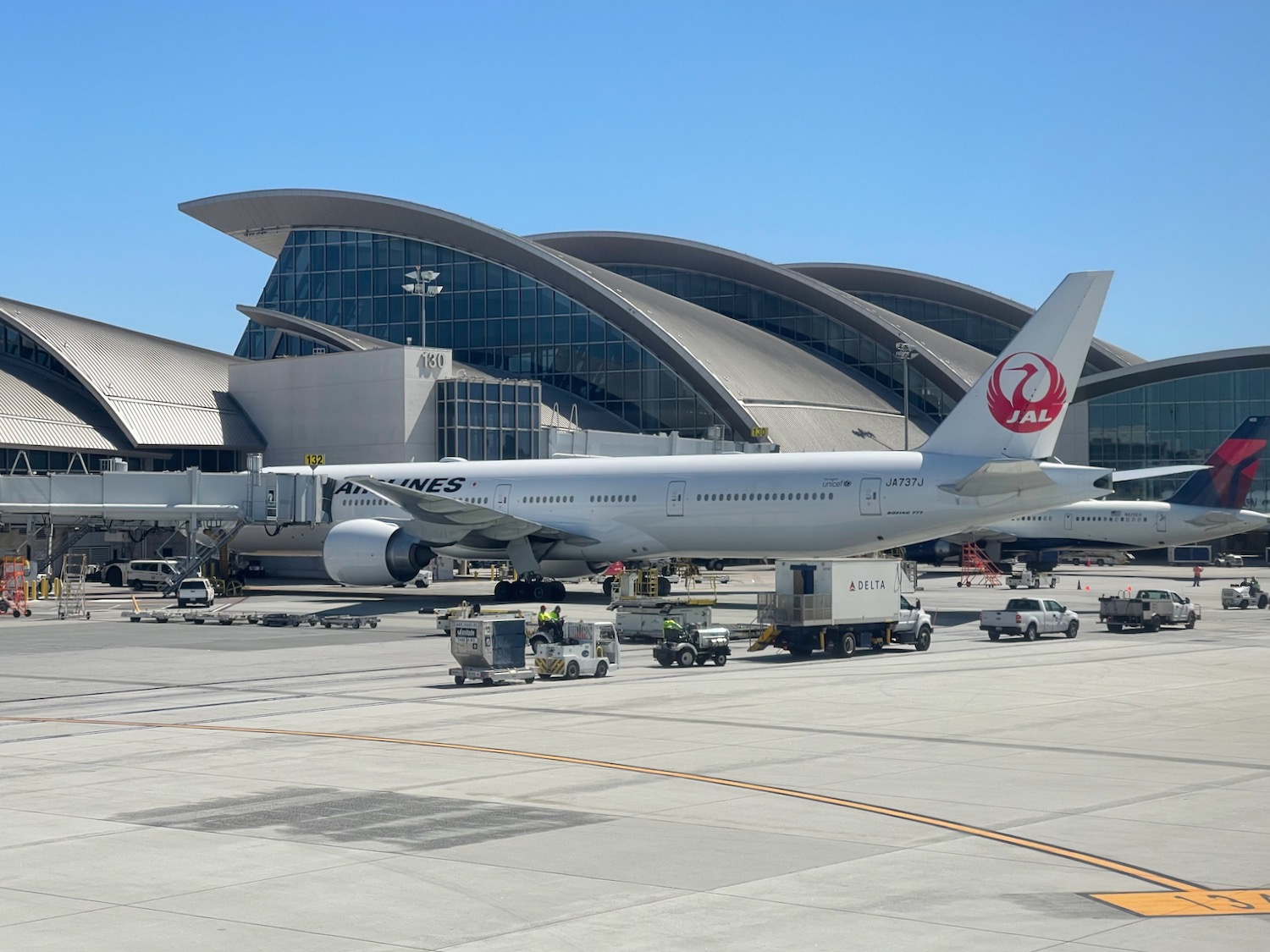 a large white airplane parked in front of a building