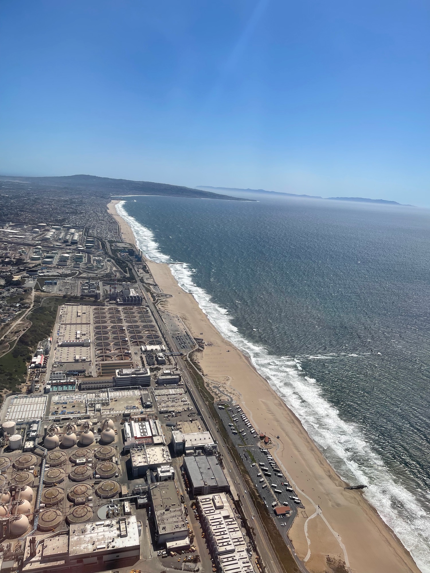 a beach with buildings and a body of water