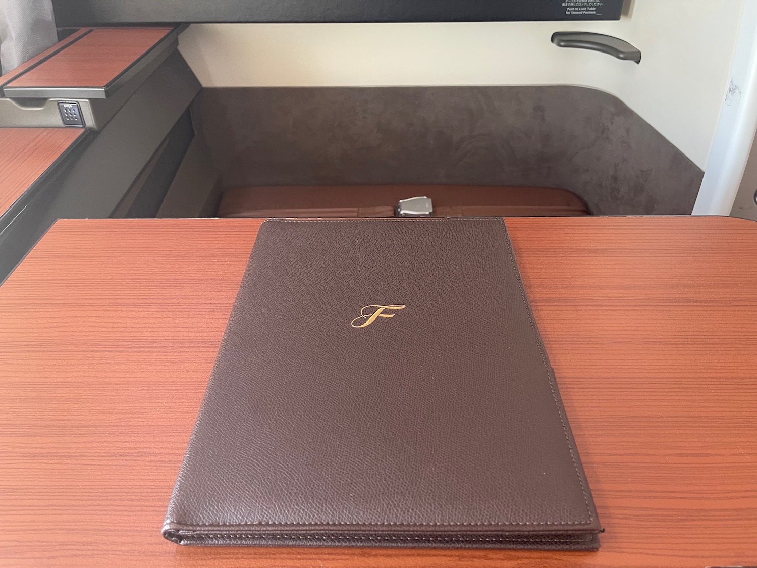a brown leather menu on a wood surface