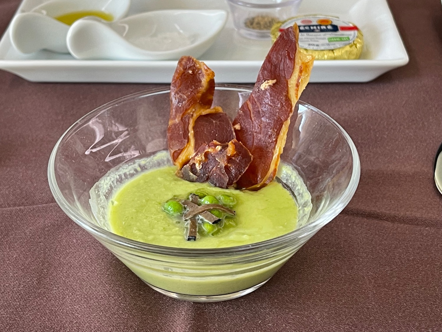 a bowl of soup with bacon