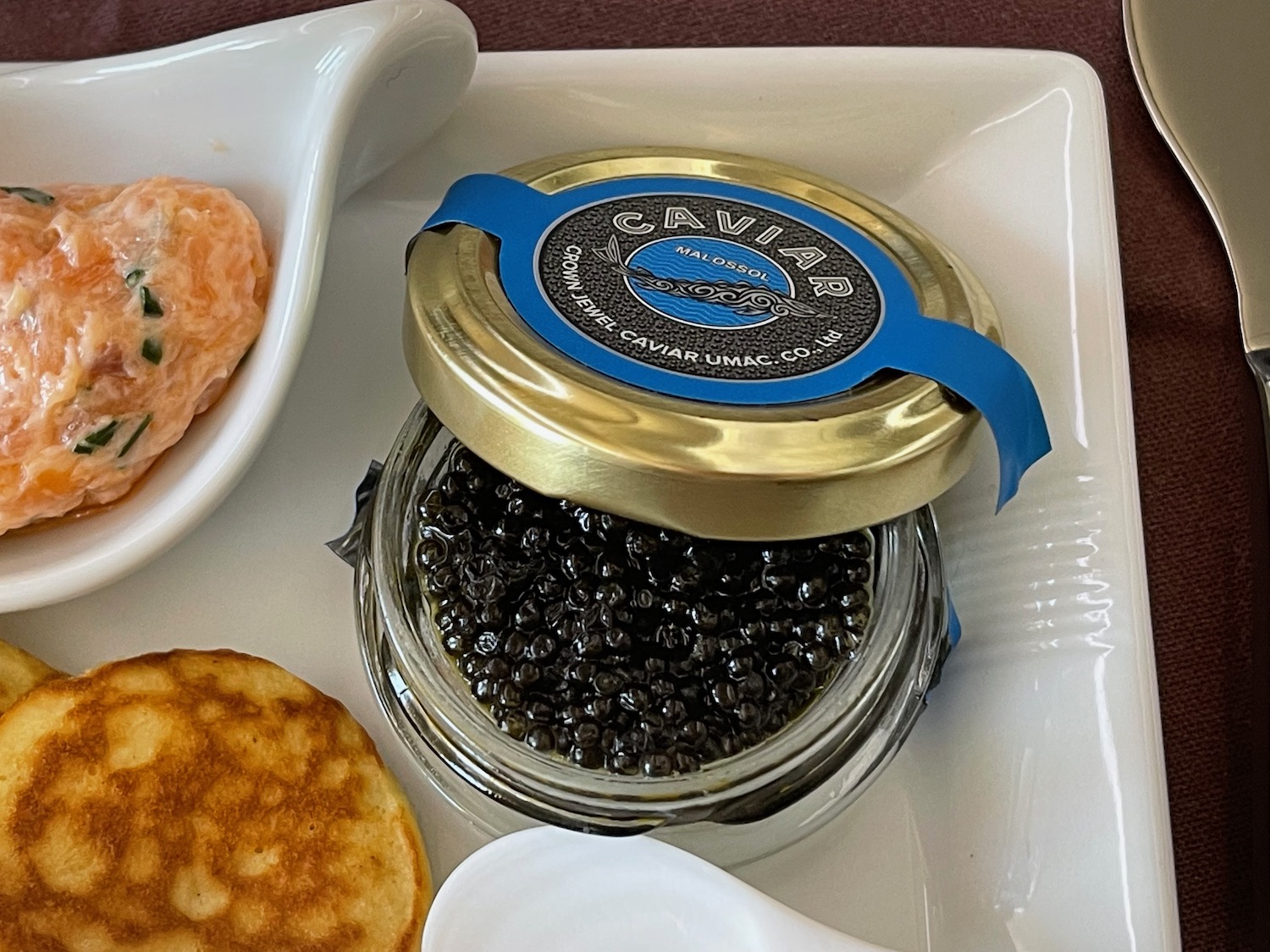 a jar of caviar on a plate