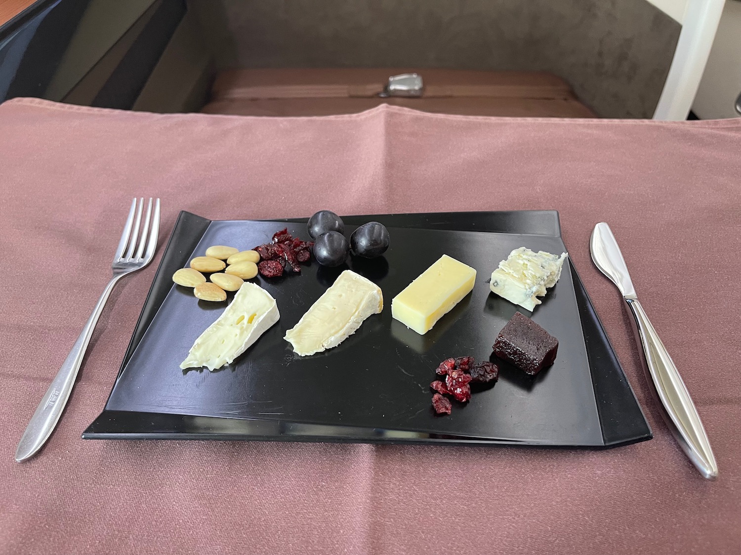 a plate of cheese and grapes