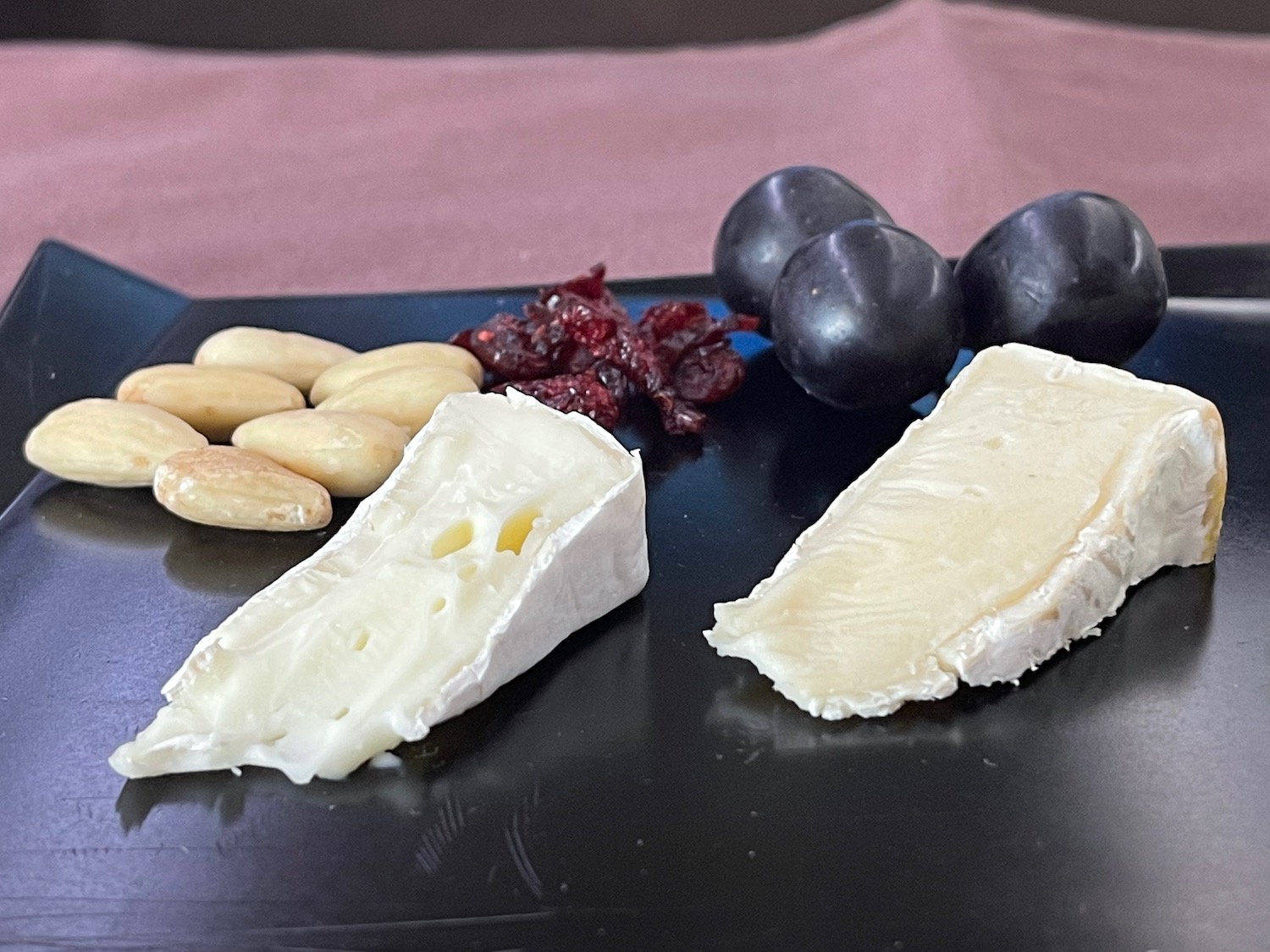 a plate of cheese and grapes