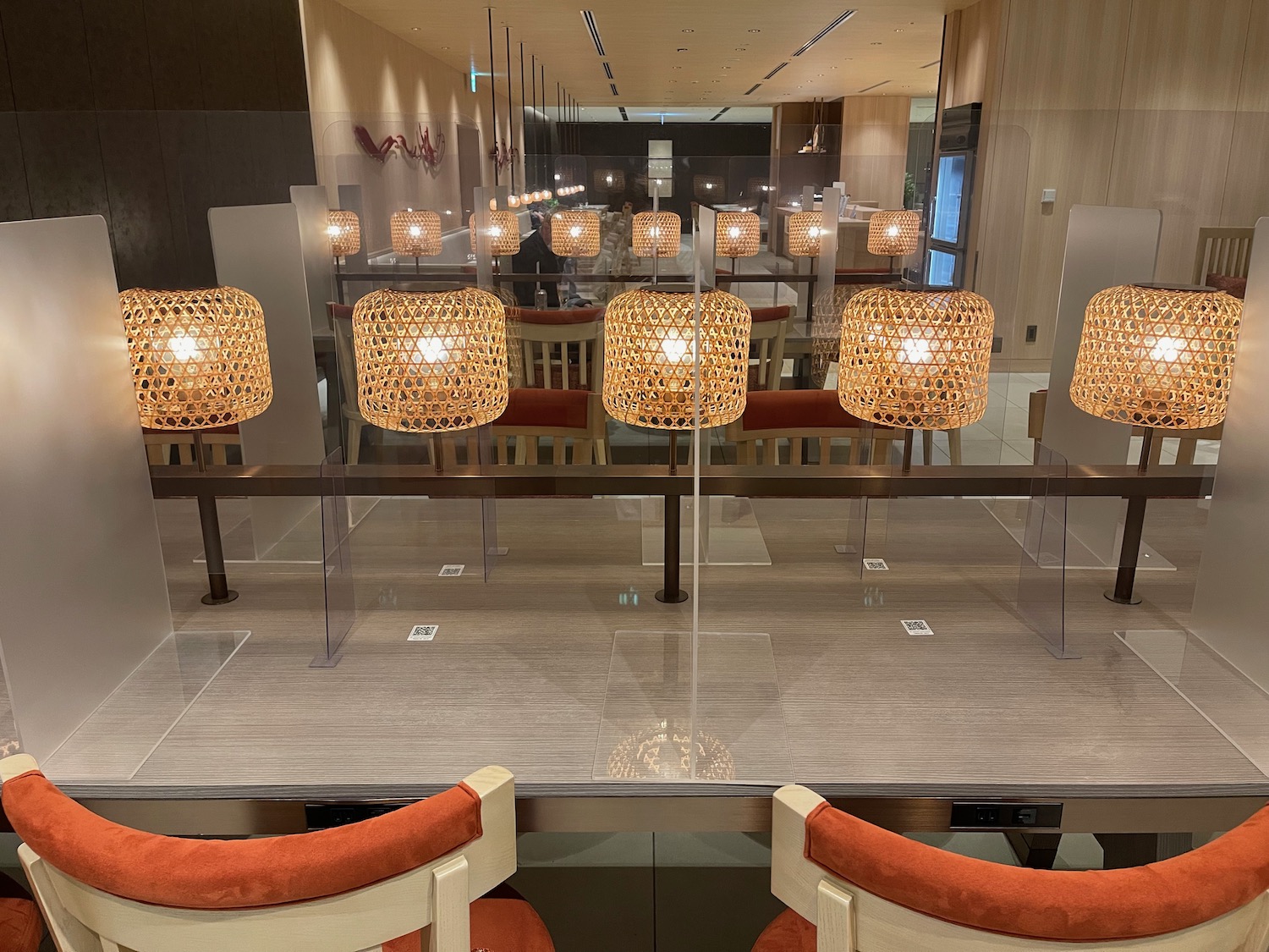 a table with a glass partition with lamps on it