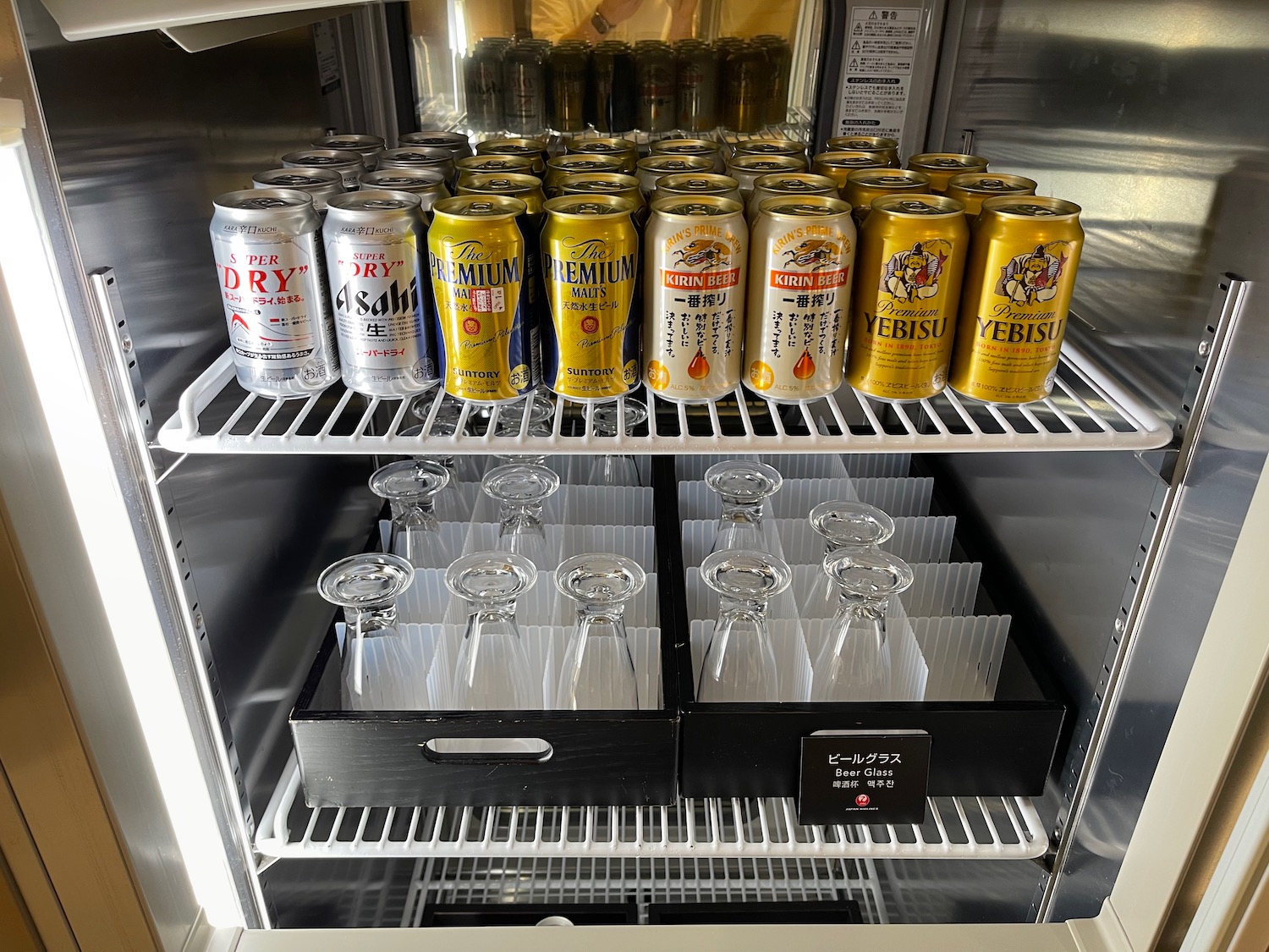 a refrigerator full of beer and glasses