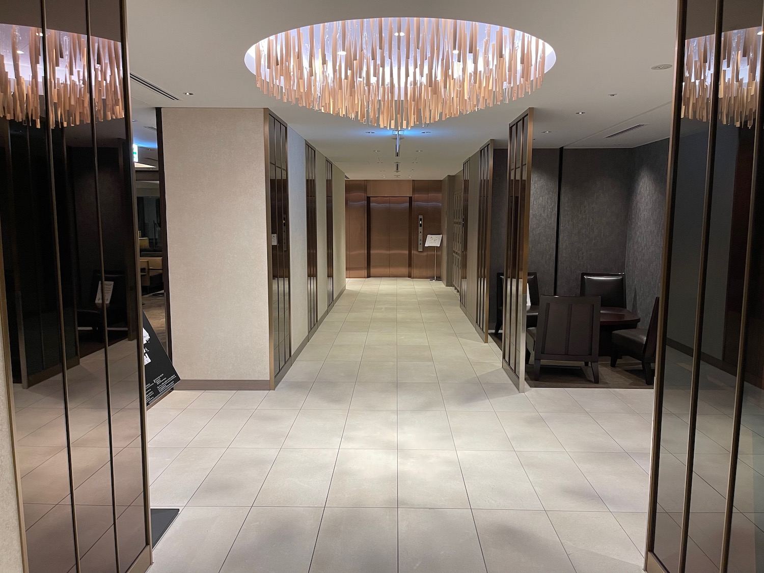 a hallway with a chandelier and doors