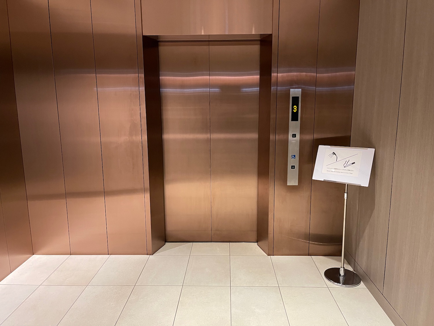 an elevator with a sign in front of it