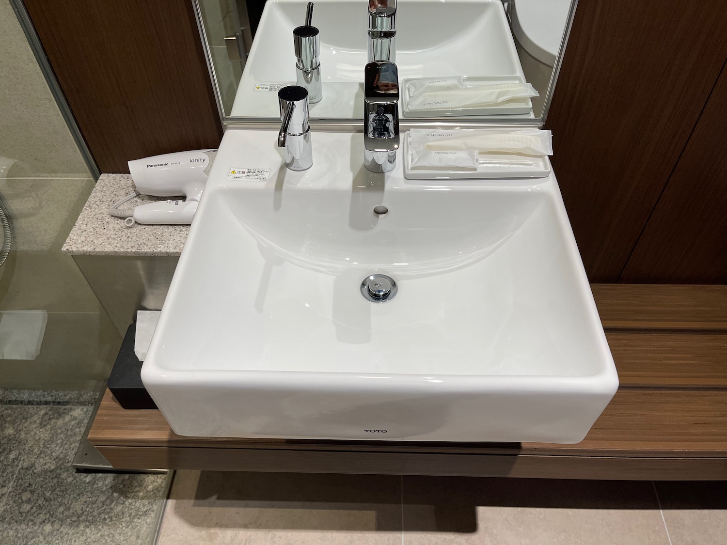 a white sink with silver faucets