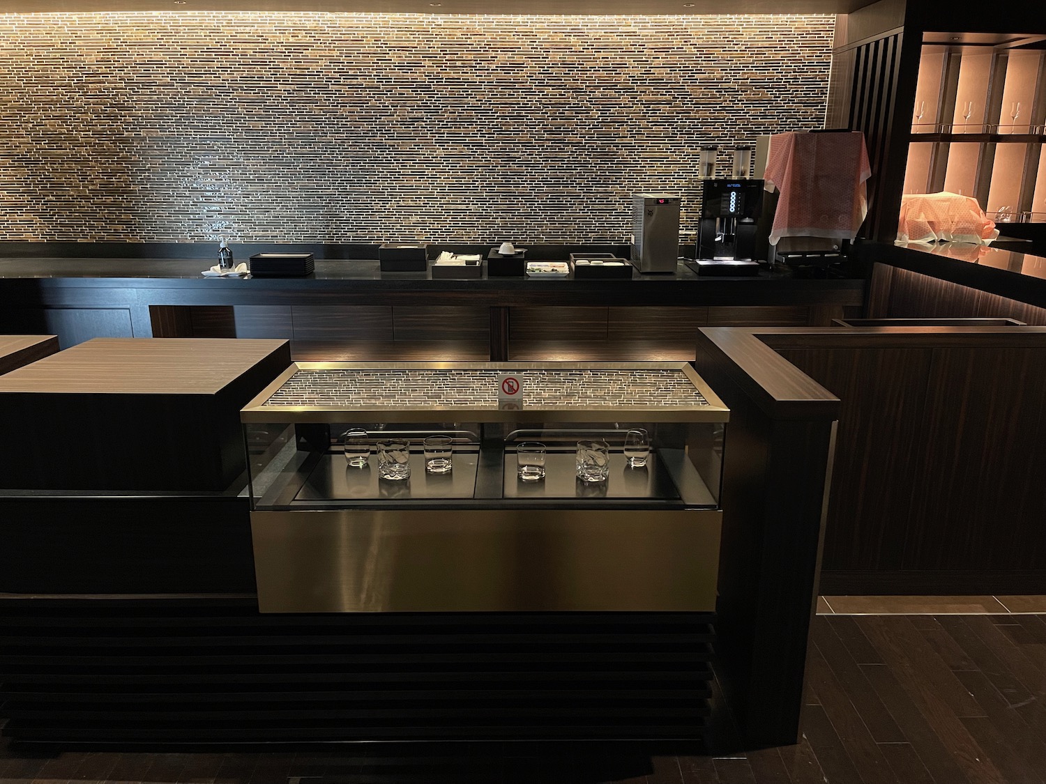 a counter with a bar and a counter with a glass top
