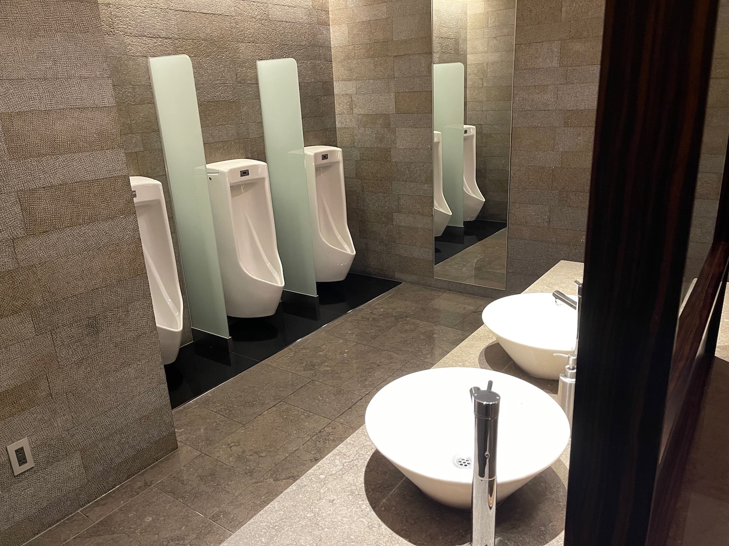 a bathroom with urinals and sinks