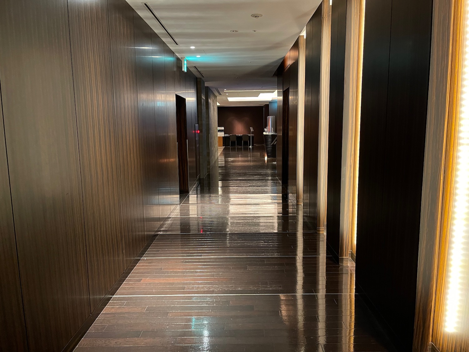 a hallway with dark wood floors