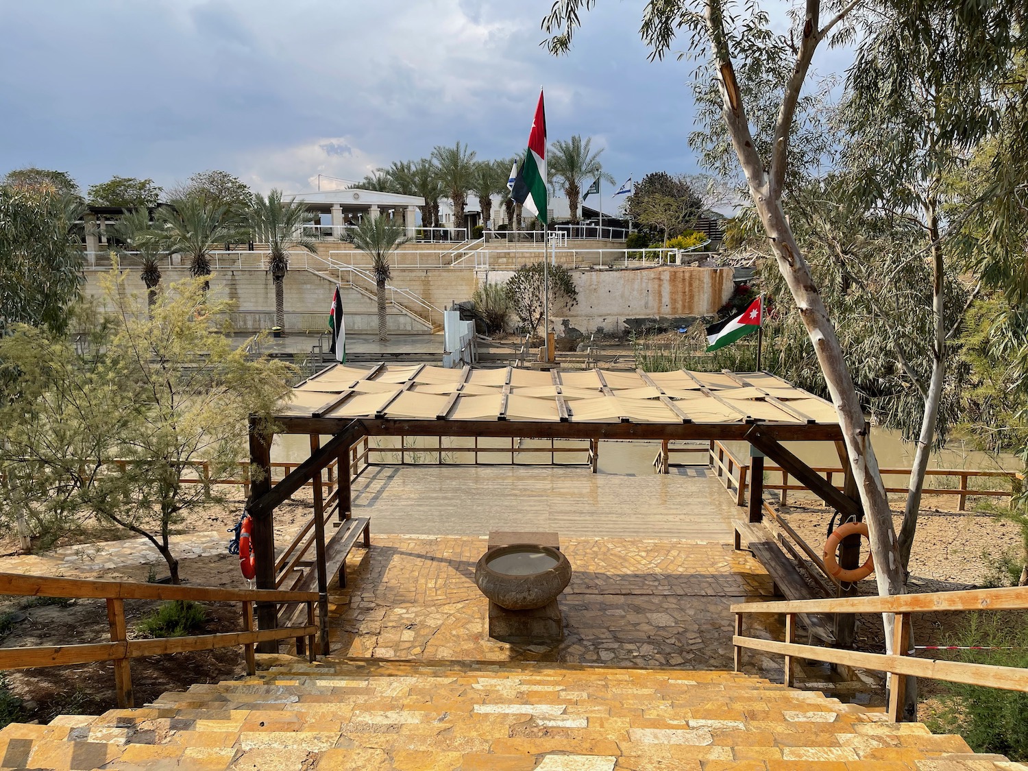 a wooden structure with a flag in the background