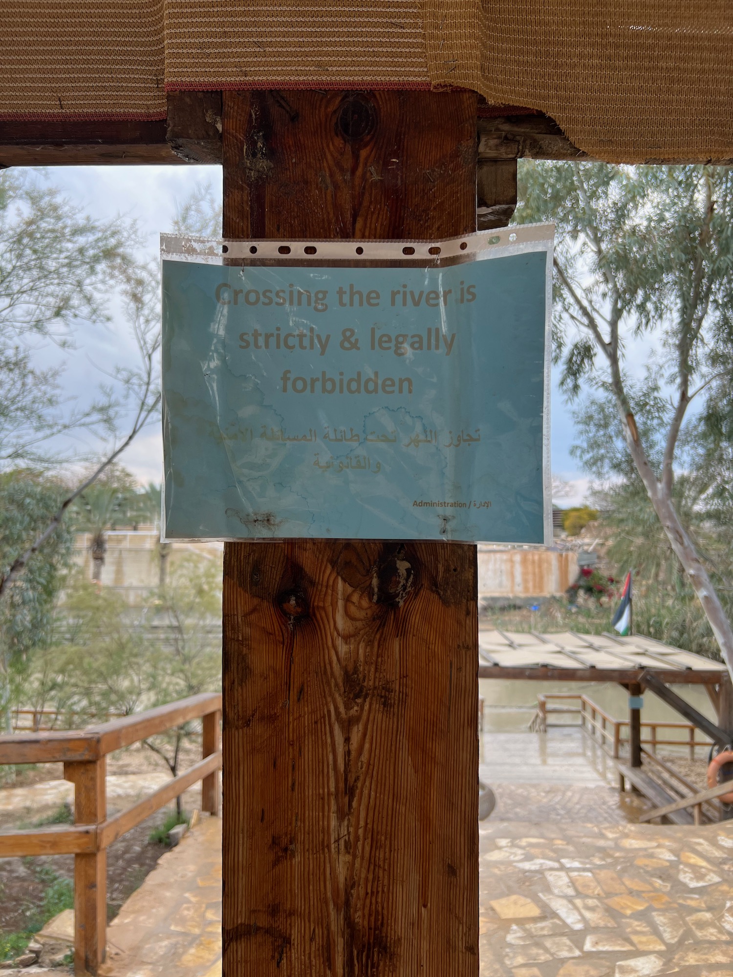 a sign on a wooden post