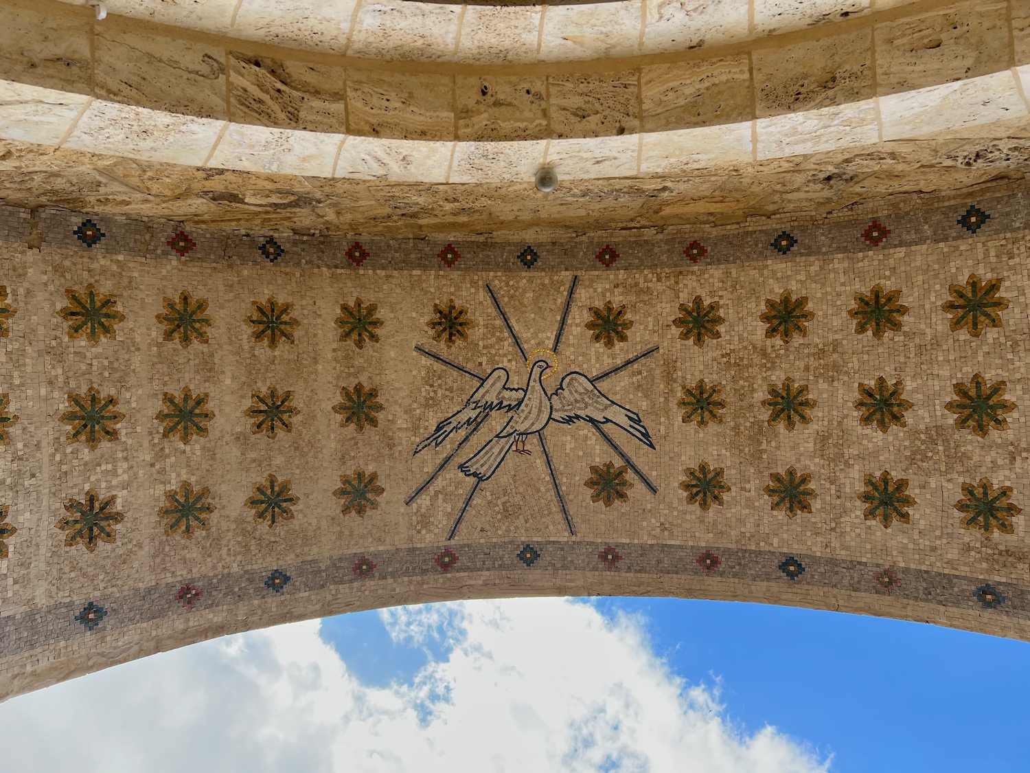 a stone archway with a mosaic design