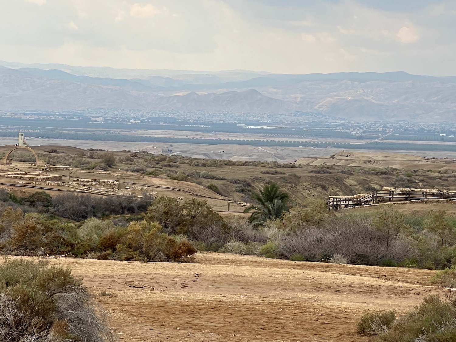 a landscape with a fence and mountains in the background