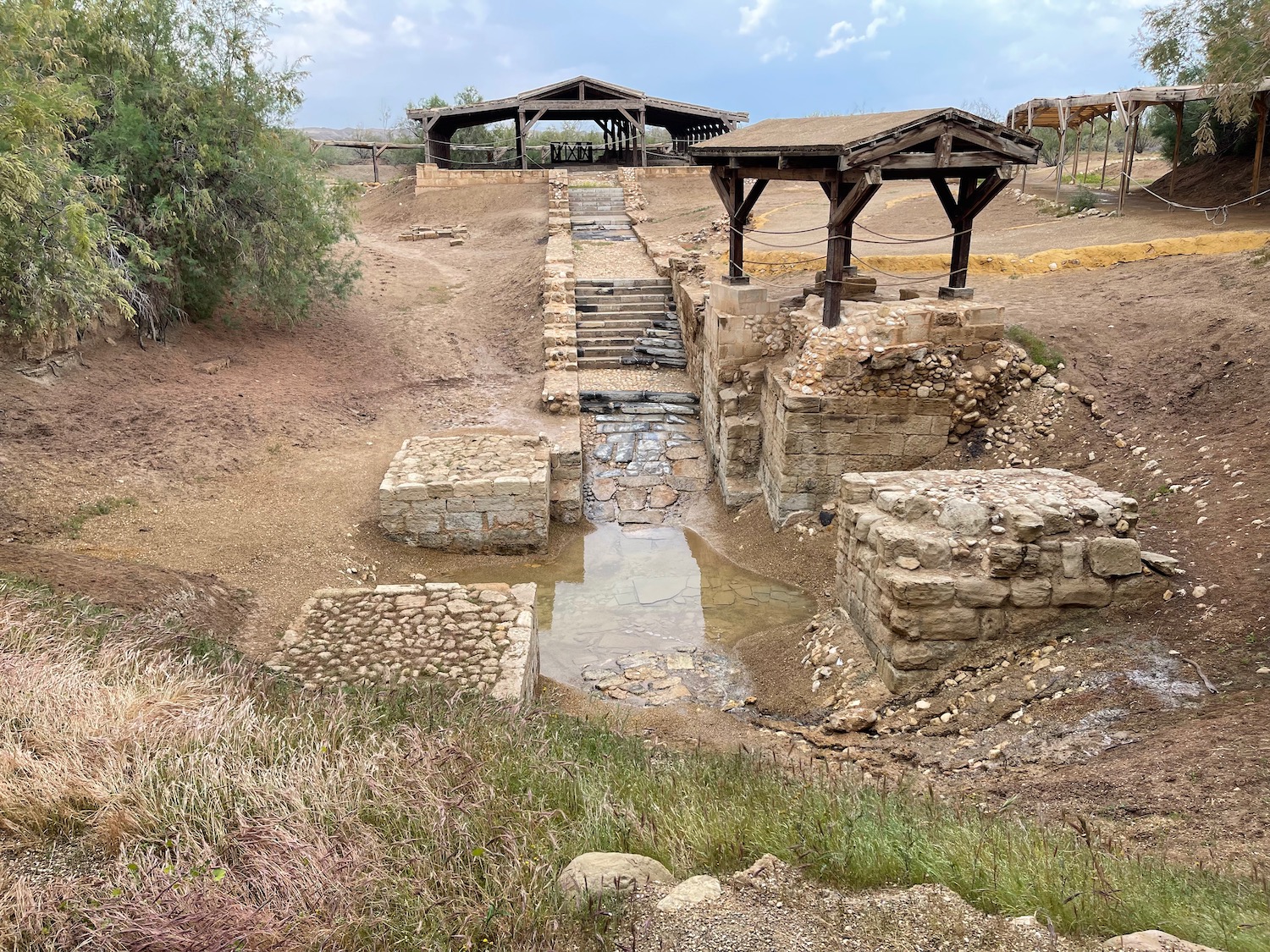 a stone structure with a stream running through it