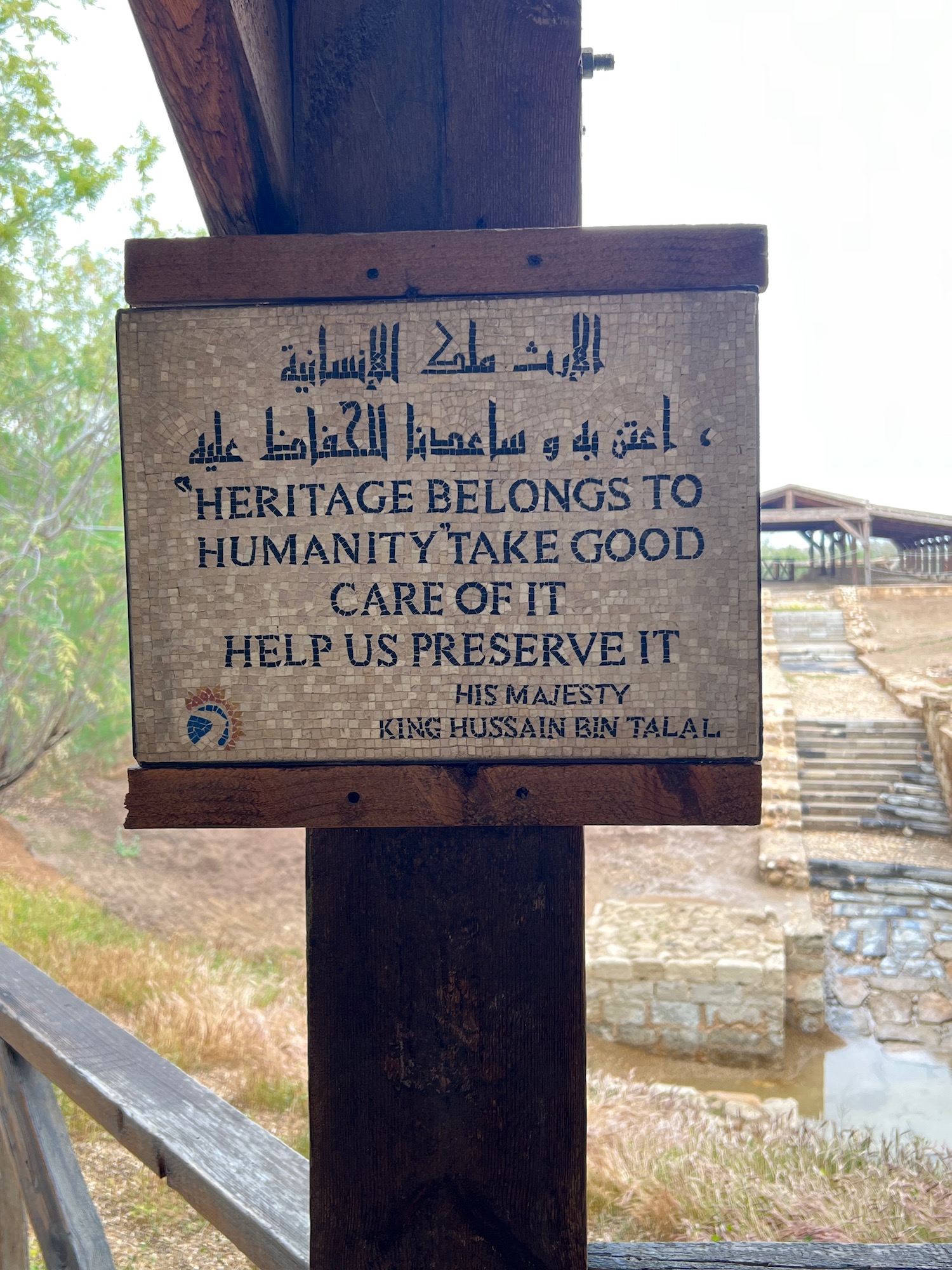 a sign on a wooden post