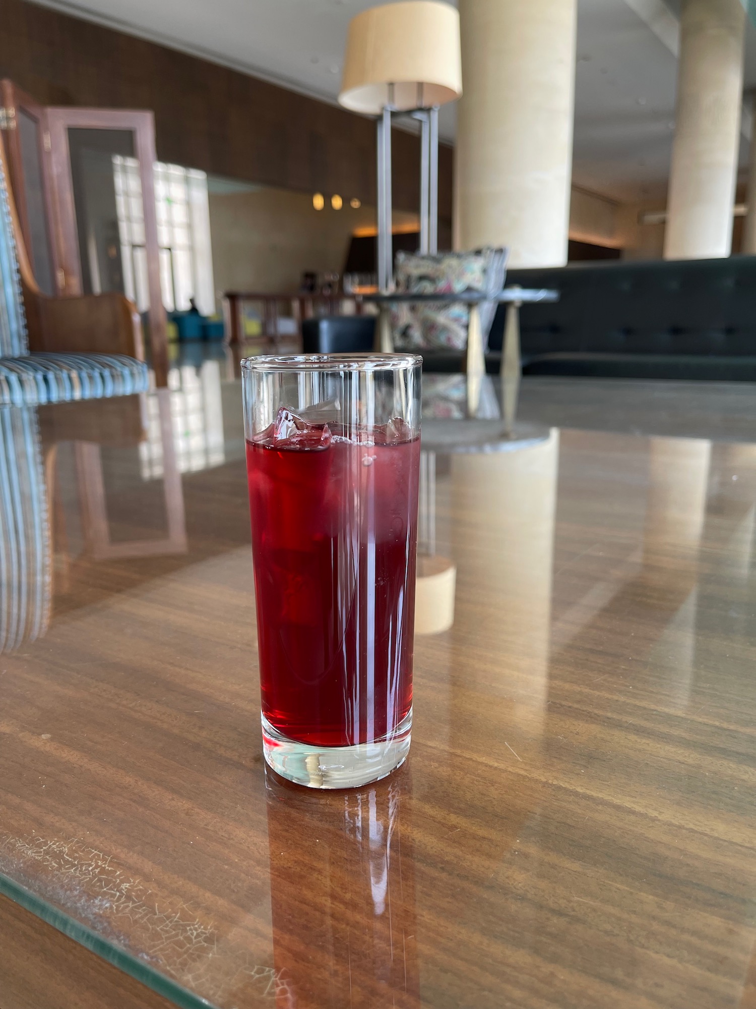 a glass of red liquid on a table