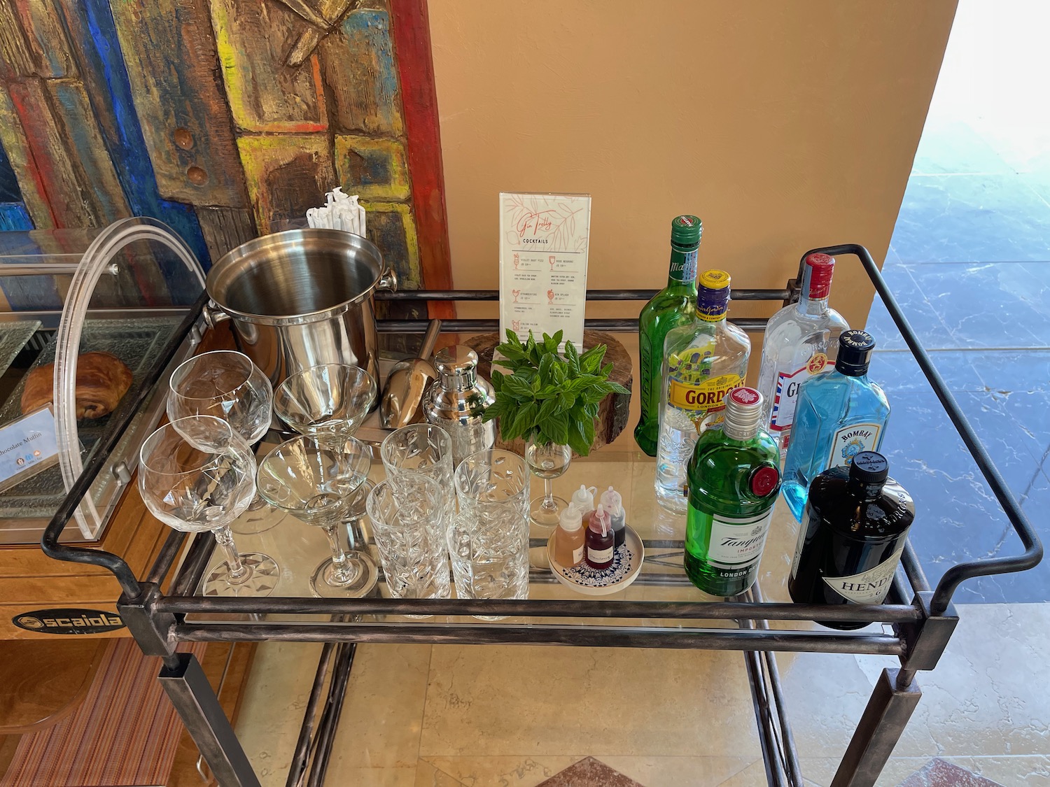 a bar cart with bottles and glasses