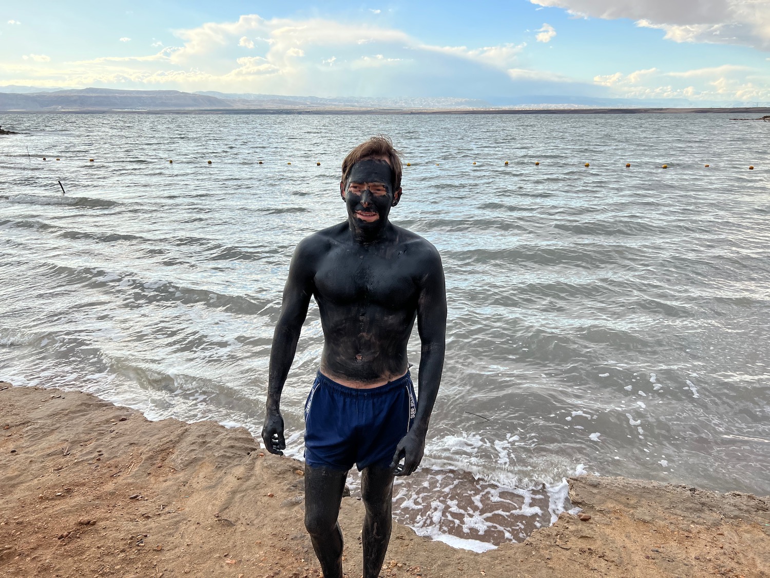 a man with black face and body of water