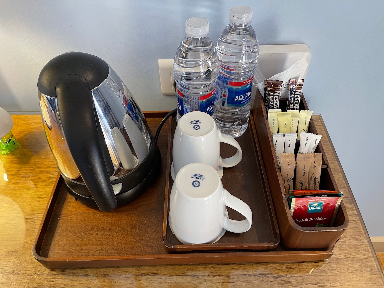a tray with coffee pot and water bottles on it