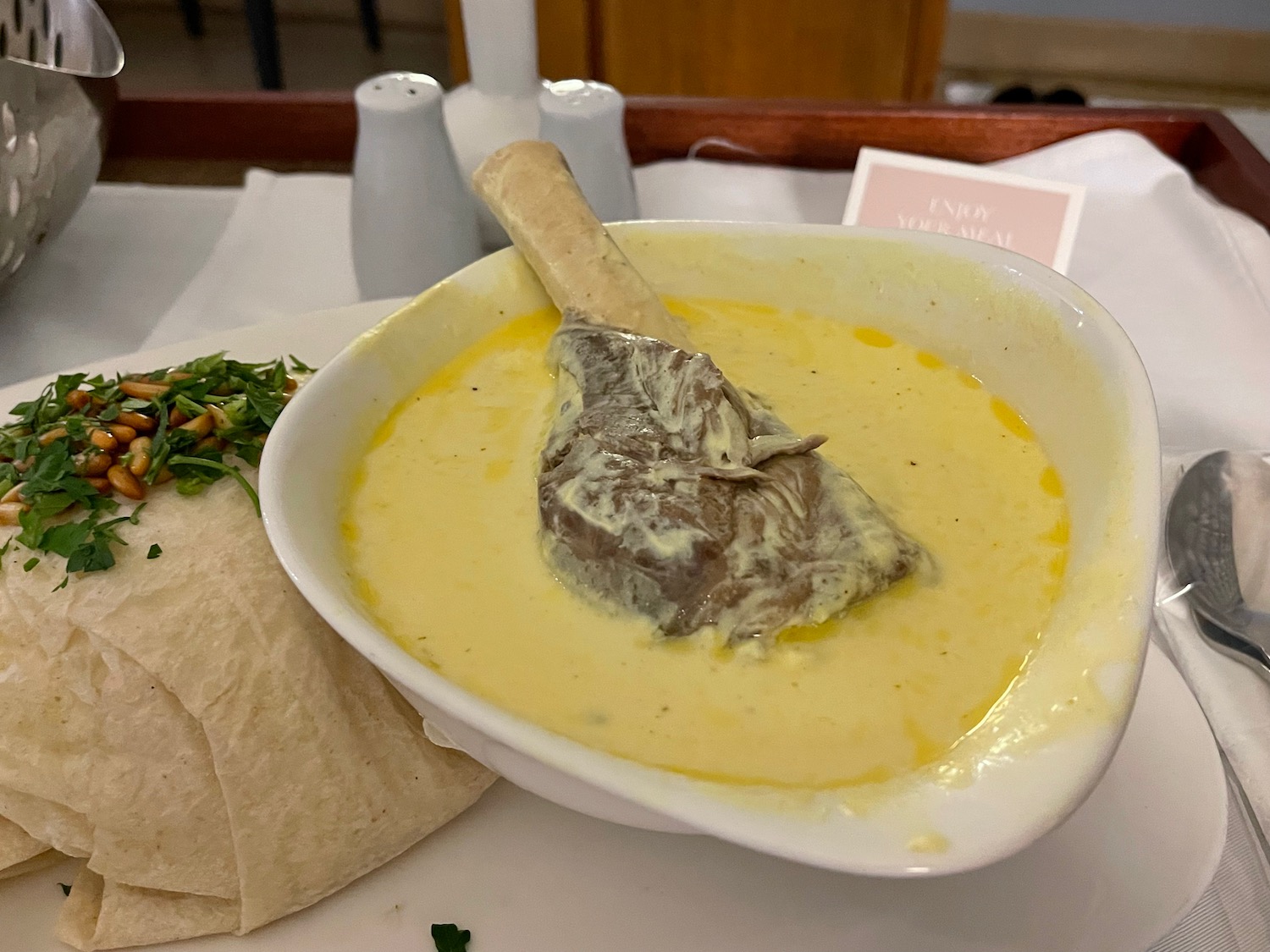 a bowl of soup with a bone in it