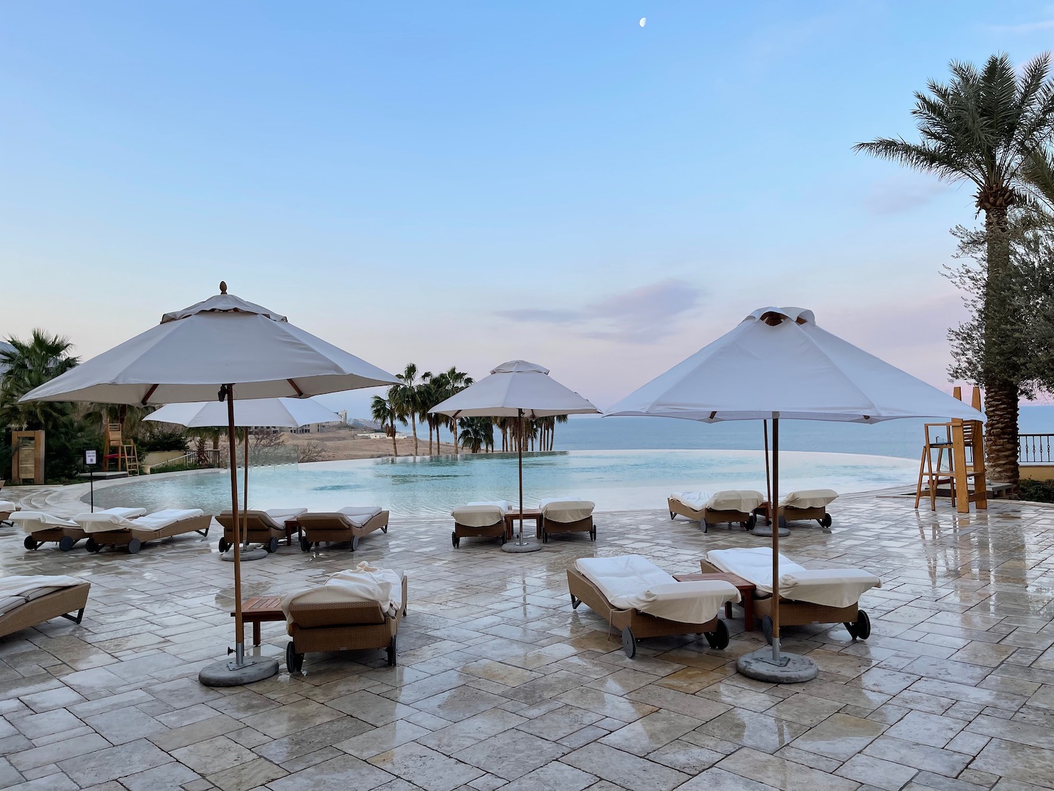 a pool with lounge chairs and umbrellas