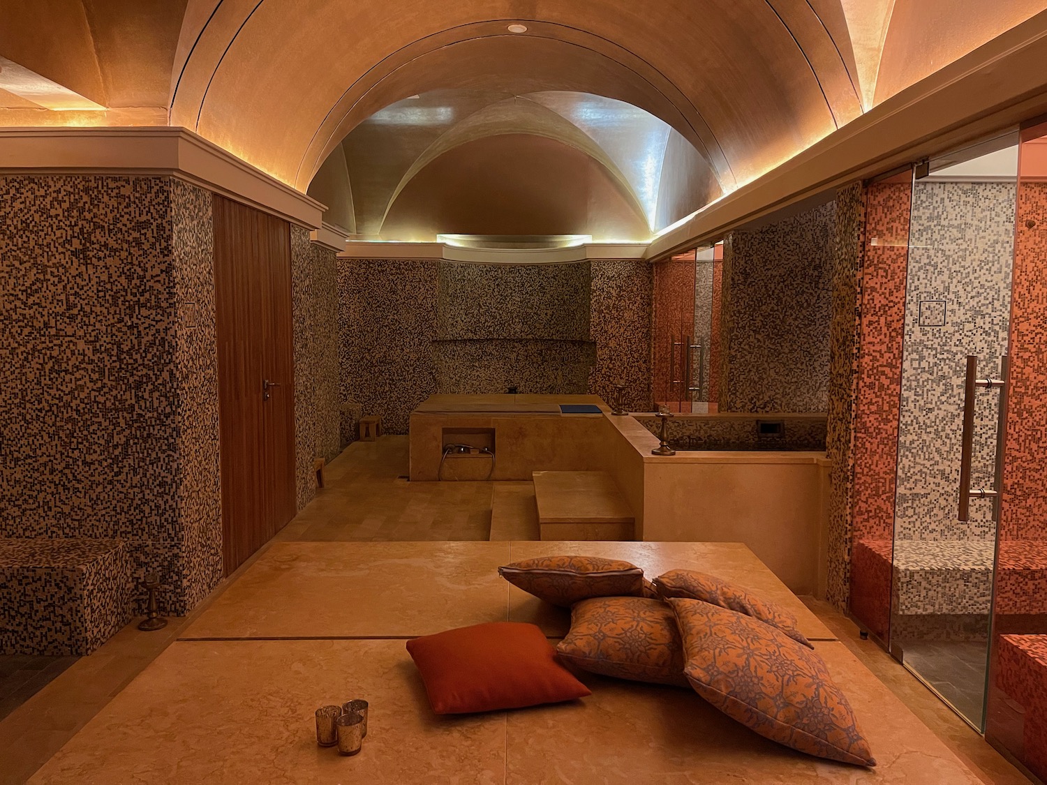 a room with a large stone floor and a large stone bathtub