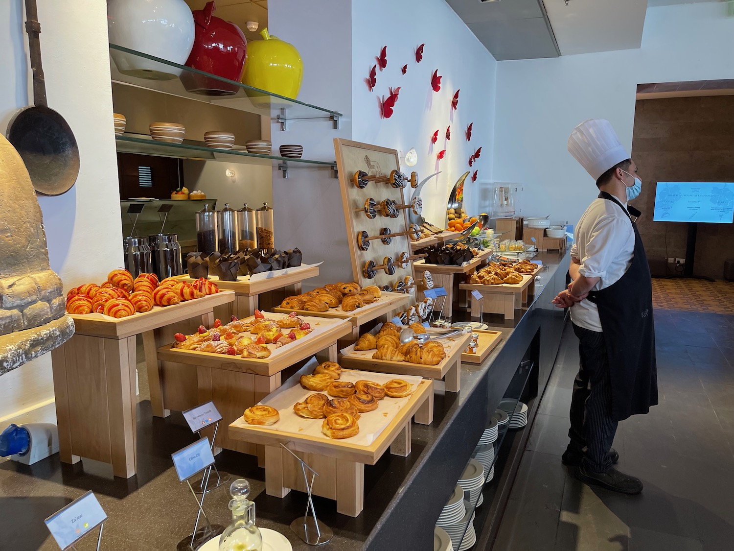 a chef standing in front of a counter with food on it