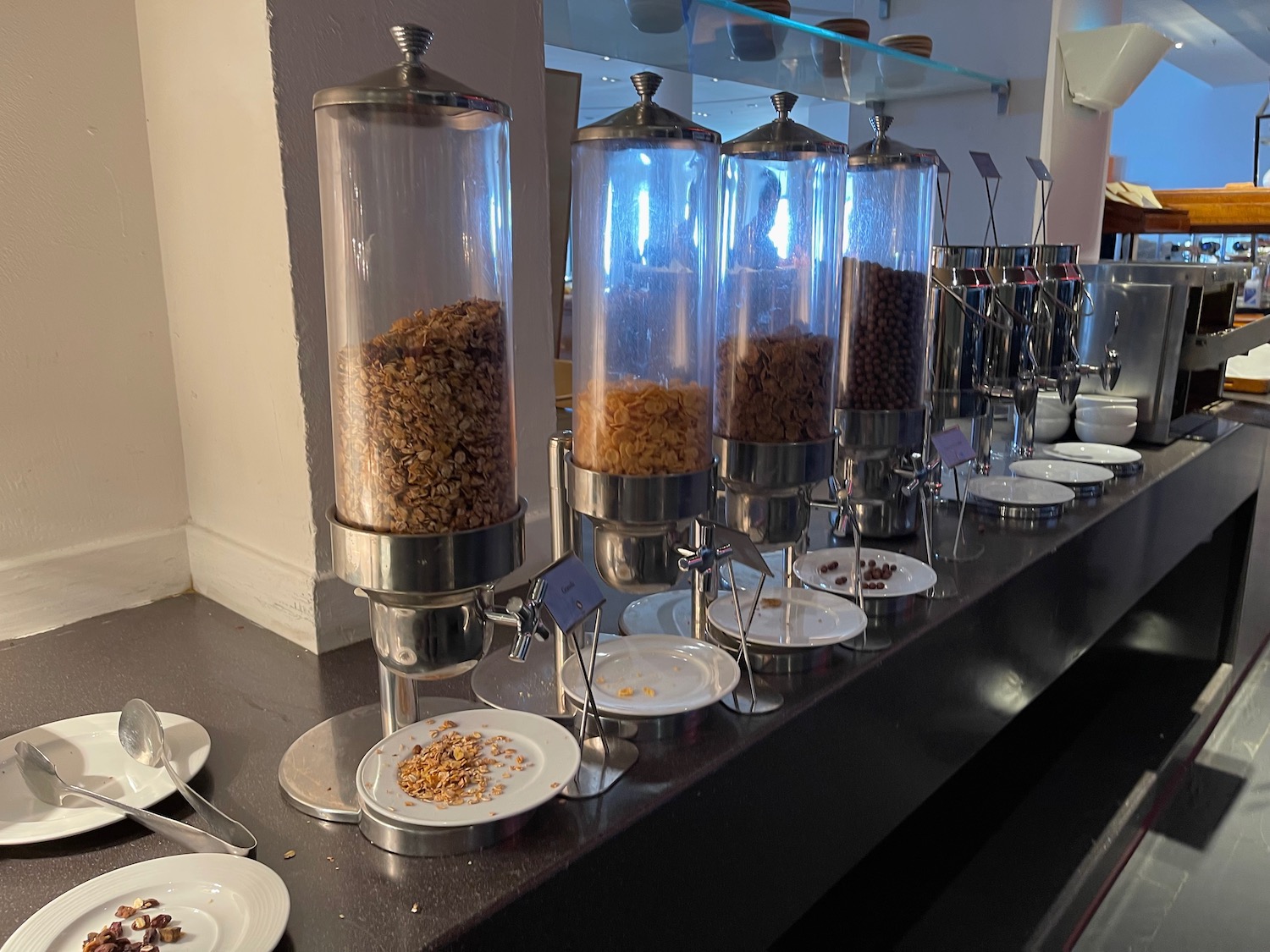 a row of cereal dispensers on a counter