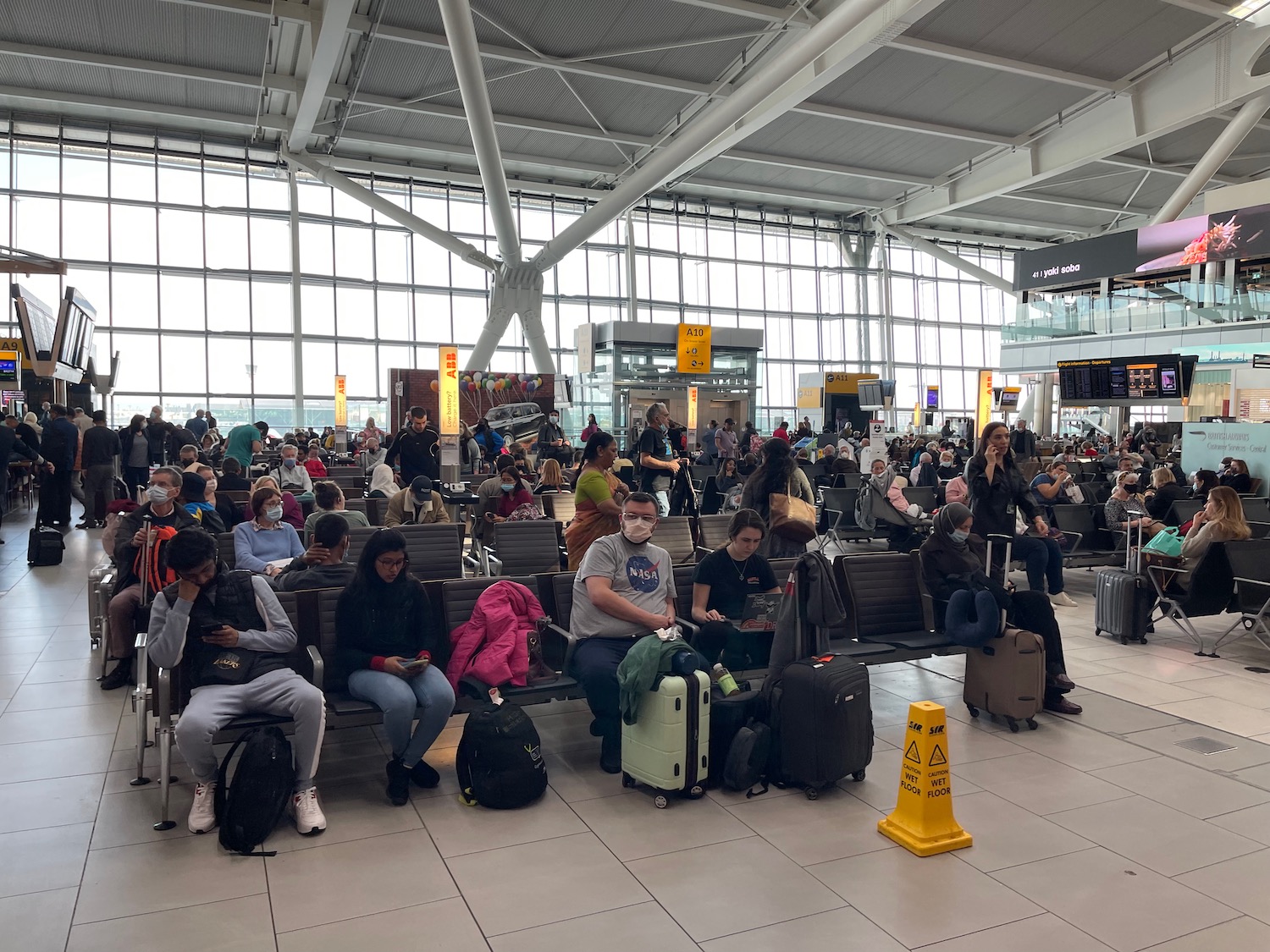 a group of people sitting on benches in a terminal